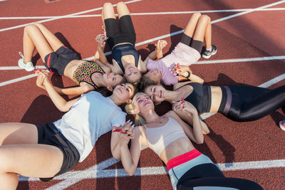 High angle view of people sitting on field