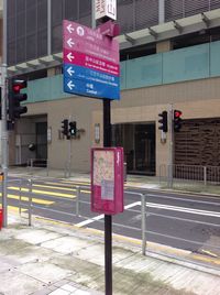 Road sign against built structures