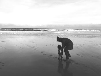 Full length of man on beach against sky