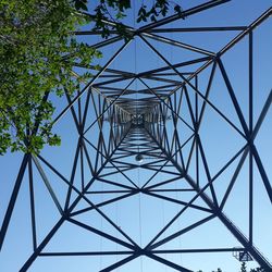 Low angle view of electricity pylon against sky