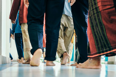 Low section of people on tiled floor