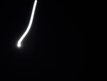 Low angle view of illuminated light against sky at night