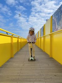 Rear view of woman walking on pier