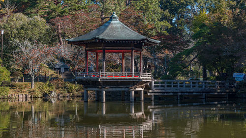 Full frame close-up view of a pagoda-style gazebo and lake during the fall autumn season