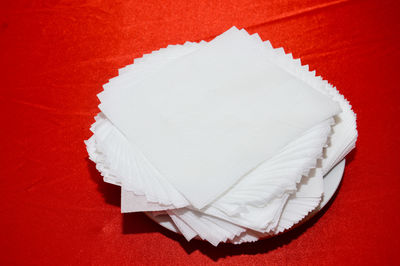 High angle view of white paper against red background