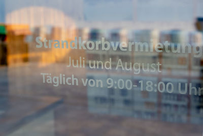 Close-up of text on glass window