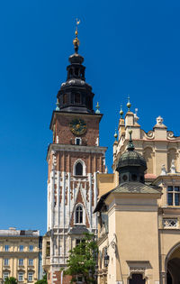 Low angle view of buildings against clear blue sky