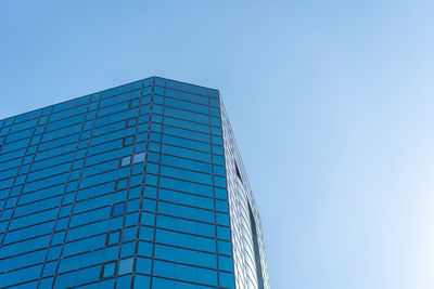 Low angle view of modern building against clear blue sky