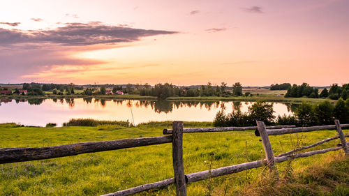 Scenic view of lake against sky during sunset