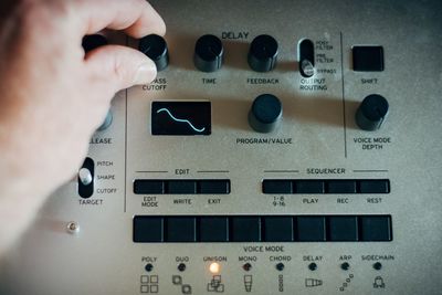 Close-up of person hand using audio equipment