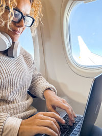 Midsection of woman using laptop