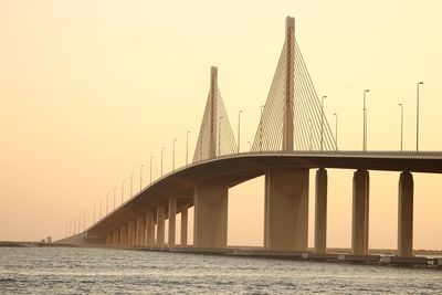 Low angle view of bridge over sea against clear sky