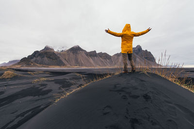 Man on black sand in desert