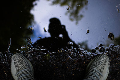 High angle view of people standing on puddle