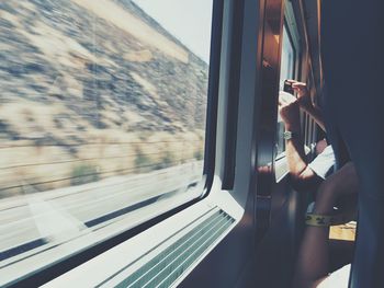 Cropped hand in train with sunlight