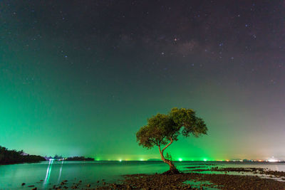 Scenic view of lake against sky at night