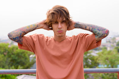 Portrait of young man standing outdoors