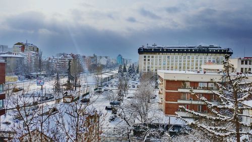 Buildings against cloudy sky