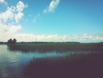 Scenic view of lake and landscape against sky