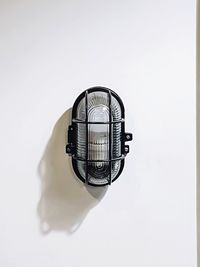 Directly above shot of electric lamp against white background