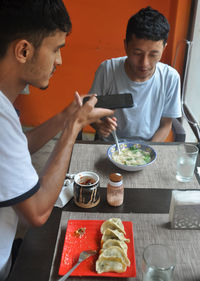 Men eating food at restaurant