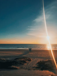 Scenic view of beach against sky during sunset