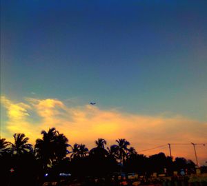 Silhouette palm trees against sky during sunset