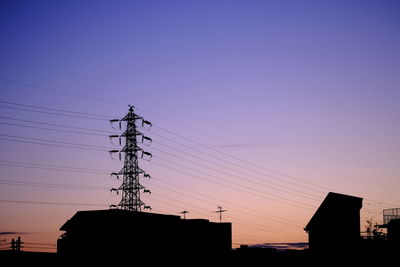Low angle view of silhouette buildings against clear sky