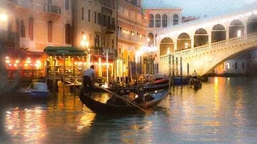 Boats in canal with buildings in background