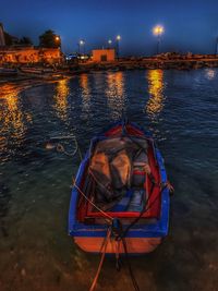 Boat moored in river at night