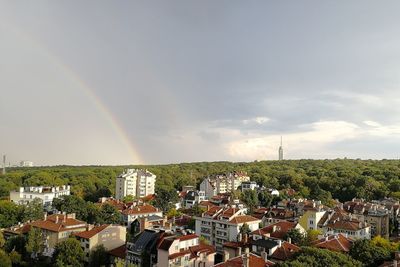 Scenic view of rainbow over buildings in city