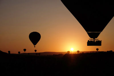 Silhouette of hot air balloon against sky during sunset