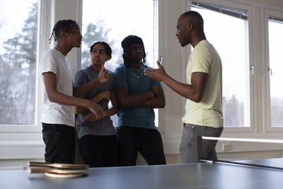 Students and coach interacting with each other in games room