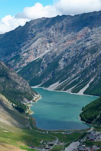 High angle view of lake and mountains against sky