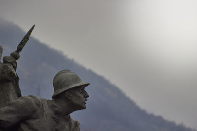 Low angle view of angel statue against sky