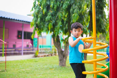 Portrait of smiling boy playing at playground