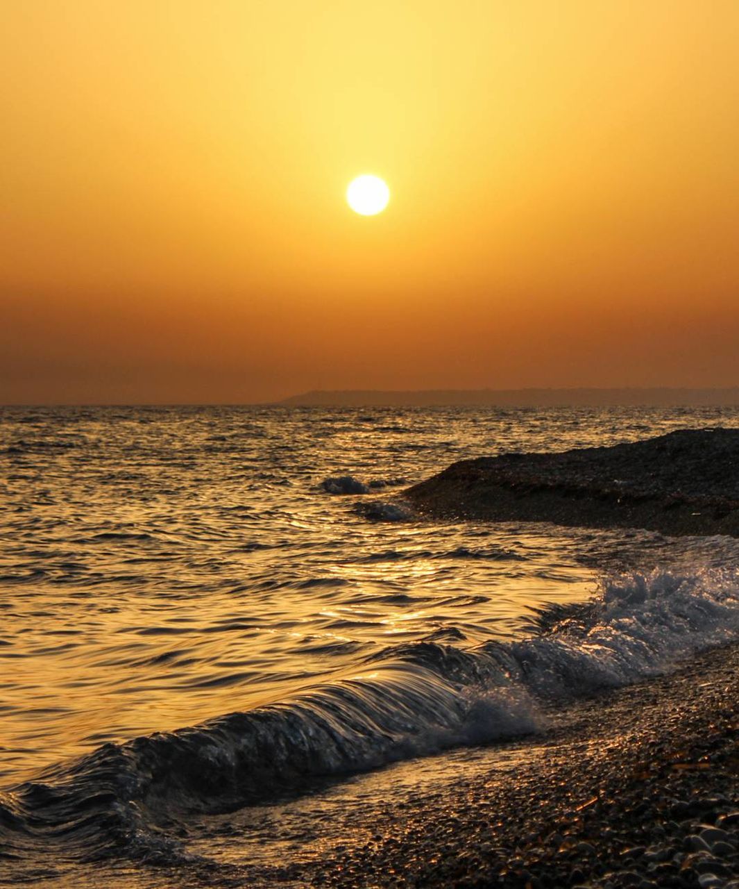 SCENIC VIEW OF BEACH DURING SUNSET