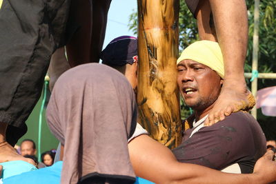 Midsection of man and woman standing outdoors