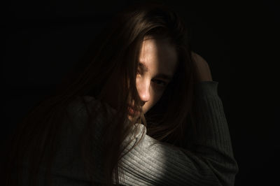 Young woman over black background