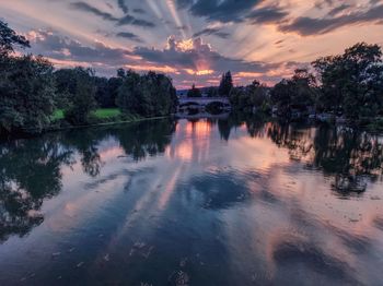 Scenic view of lake against sky at sunset