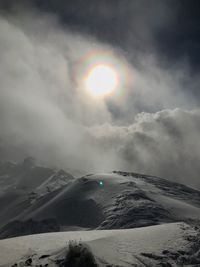 Scenic view of snow covered mountains against sky