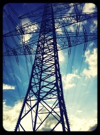 Low angle view of electricity pylon against sky
