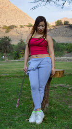 Portrait of smiling young woman on field