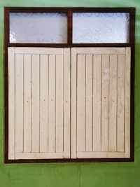 Close-up of closed wooden door of building