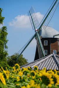 Low angle view of windmill against sky