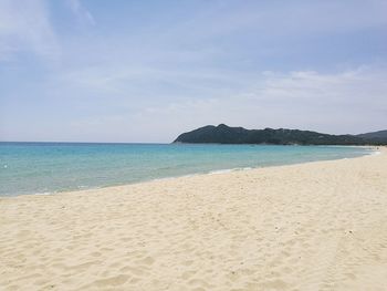 Scenic view of beach and sea against sky