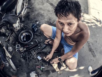 High angle view of man dancing on motorcycle