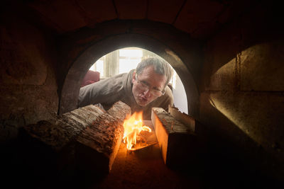 Low angle view of man standing in cave