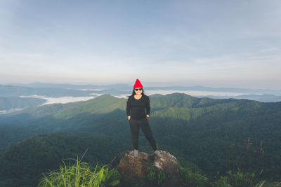 Man standing on mountain against sky