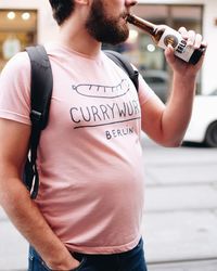 Midsection of man standing on text